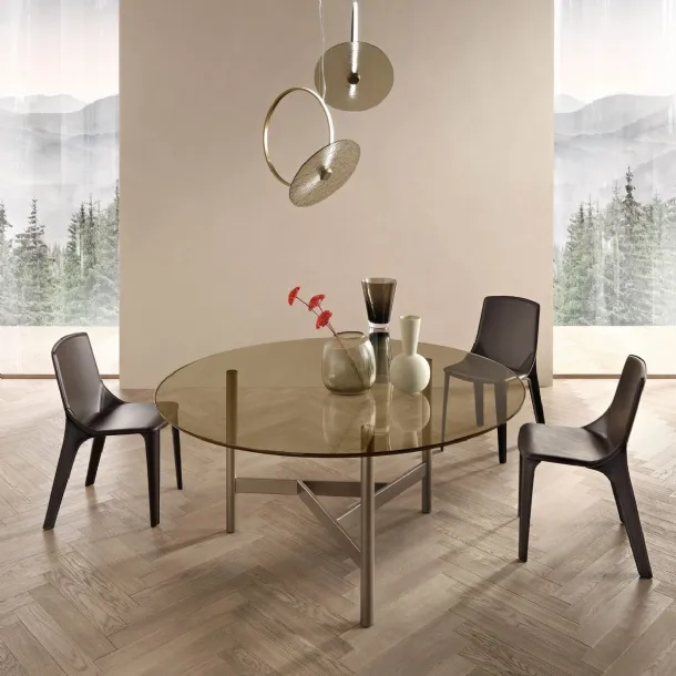 Round Agos table with glass top and metal base by Fiam.