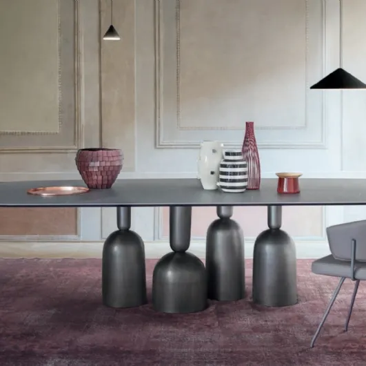 Cop Table with ceramic top and metal base formed by stylized elements inspired by bottles, precious goblets, and champagne cups by Bonaldo.