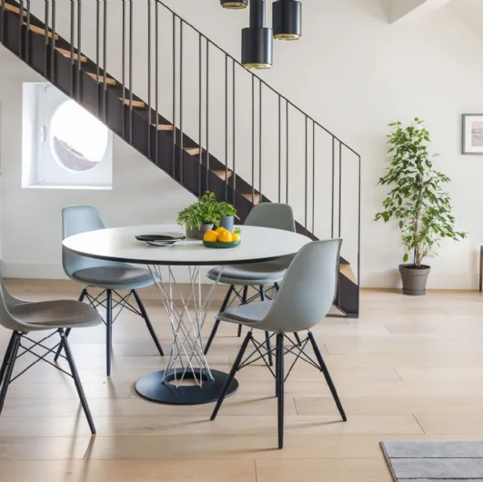 Round white HPL dining table with a metal base by Vitra