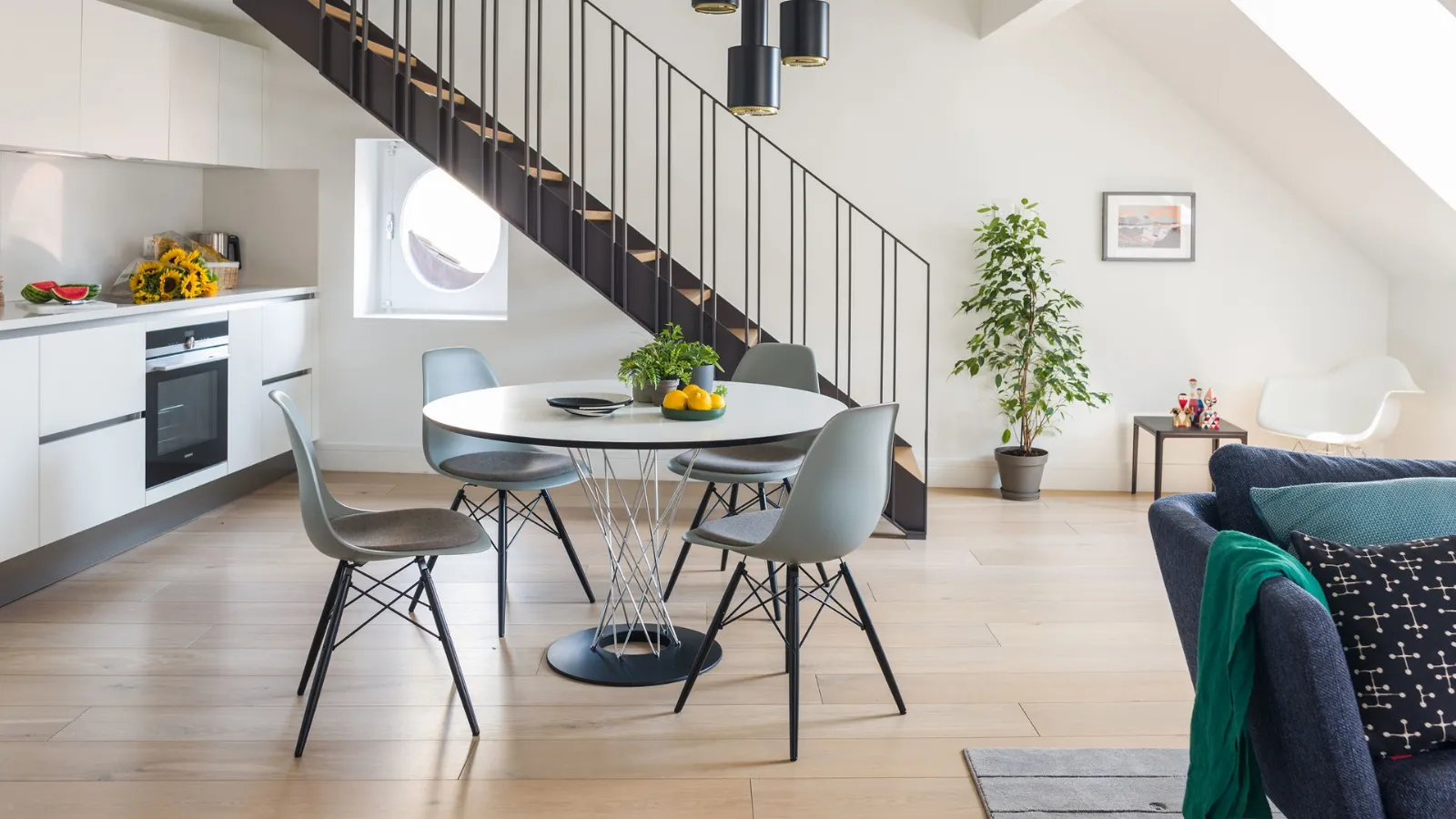 Round white HPL dining table with a metal base by Vitra