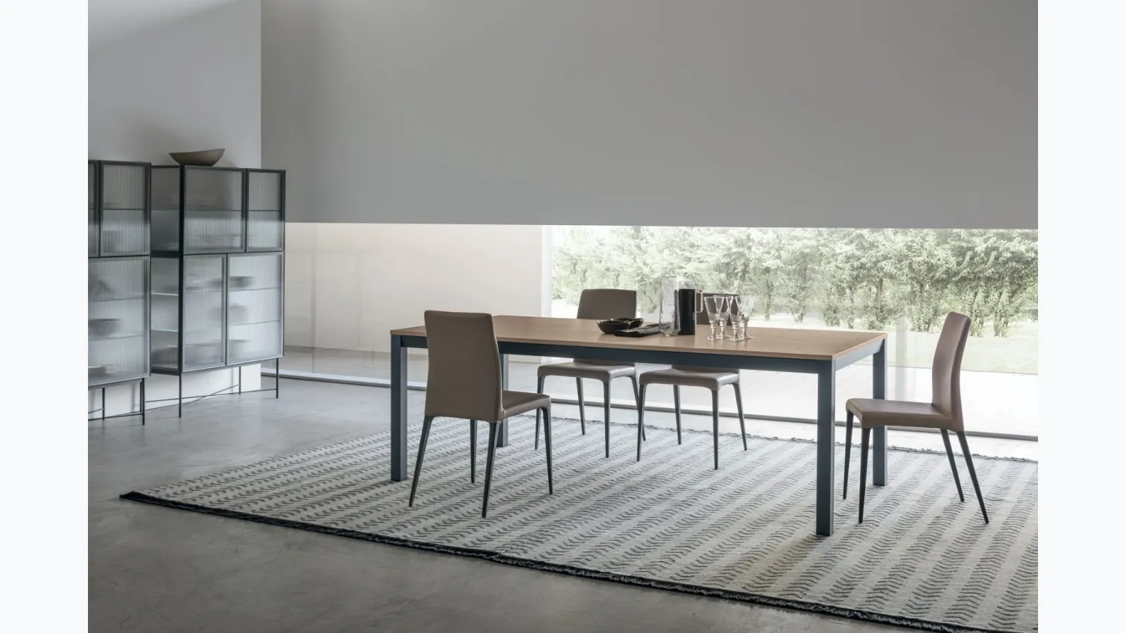 Infinity extendable table with sand-colored oak materic top and matte lacquered base by Tomasella.