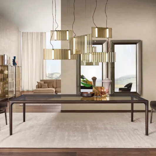 Vertigo table with glass top and solid wood base by Fiam.