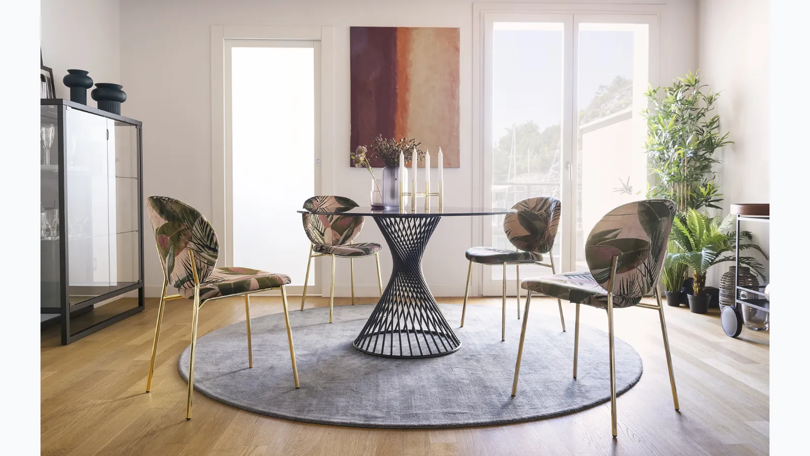 Round glass table with Vortex metal tube structure by Calligaris.