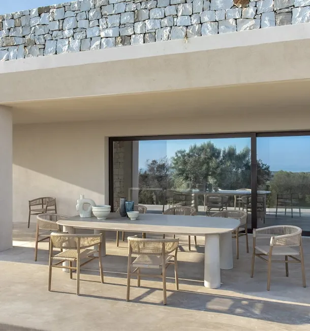 Bold stone table by Ethimo