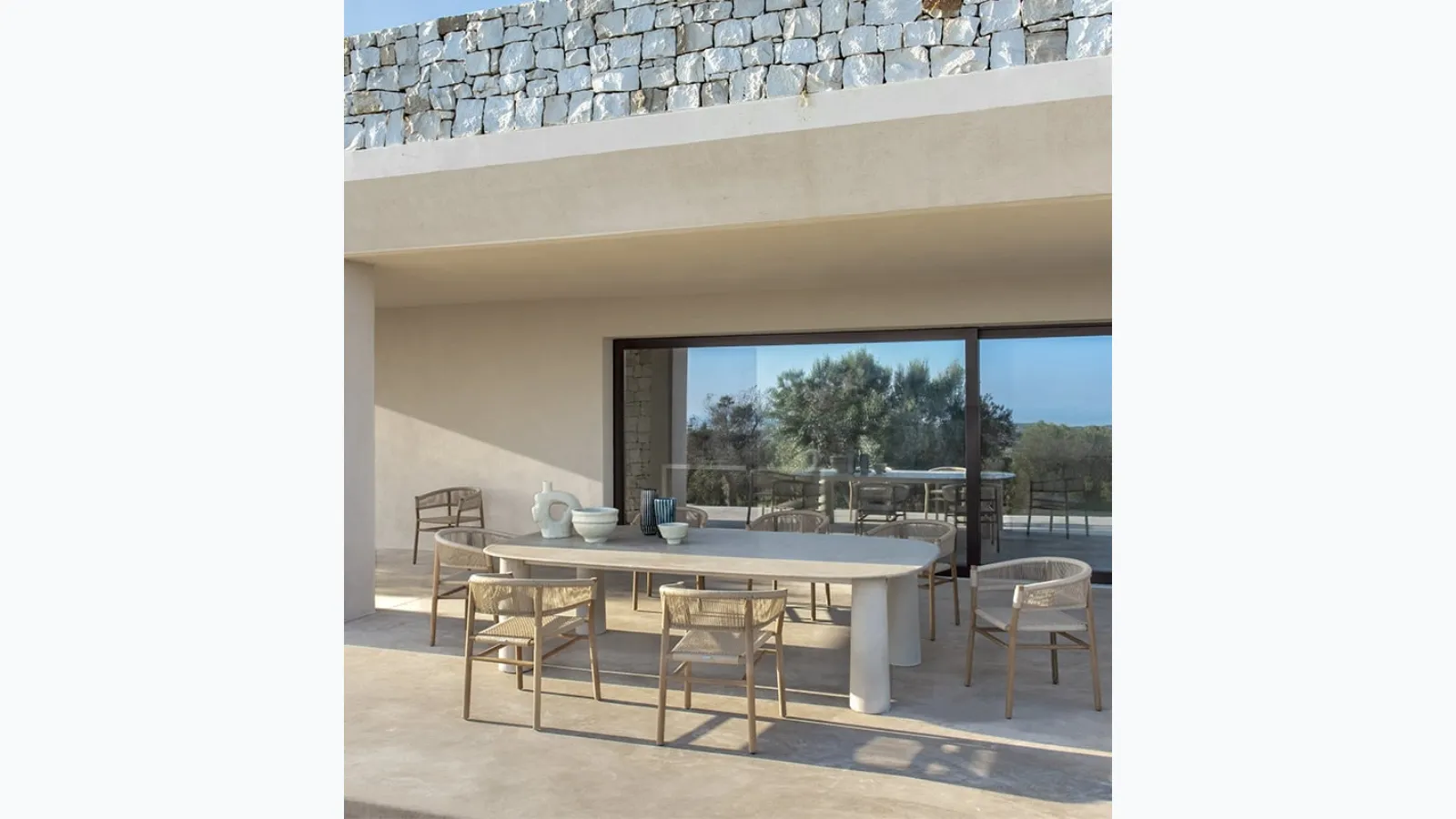 Bold stone table by Ethimo