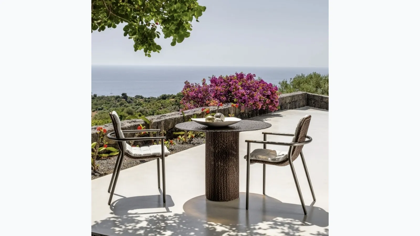 Glass table and Bond wicker chairs by Talenti.