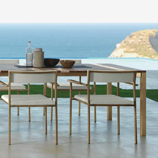 Wooden table with Casilda fabric chairs by Talenti.