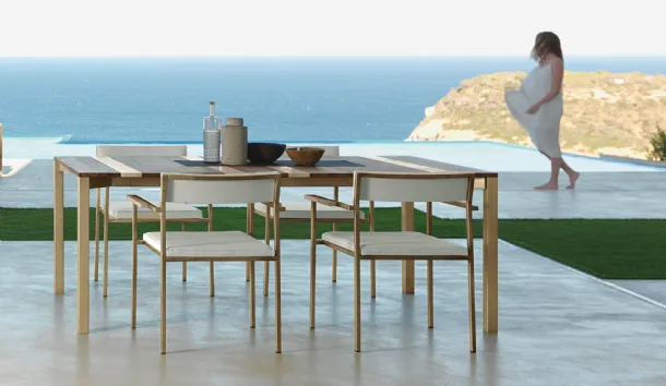 Wooden table with Casilda fabric chairs by Talenti.