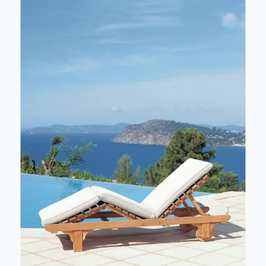Chelsea teak lounge bed with padded fabric cushion from Unopiu.