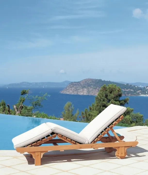 Chelsea teak lounge bed with padded fabric cushion from Unopiu.