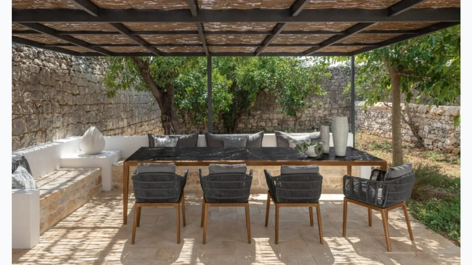 Table in stoneware and wood and Chairs in wood and Cruise Teak fabric by Talenti.