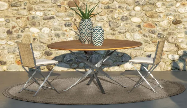 Round wooden and metal table with fabric and metal George chairs by Talenti.
