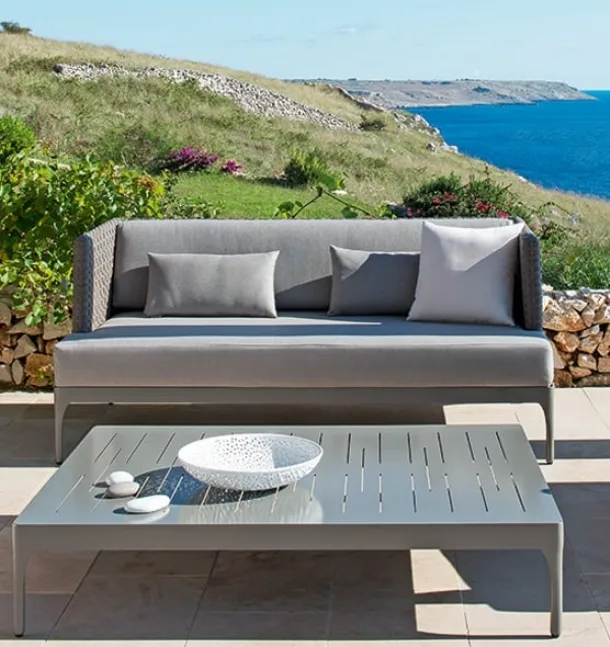 Infinity sofa in Lightwick fiber and aluminum coffee table by Ethimo.