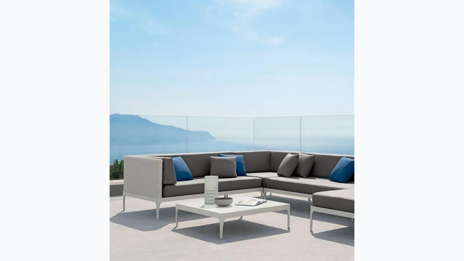 Infinity sofa in Lightwick fiber and aluminum coffee table by Ethimo.