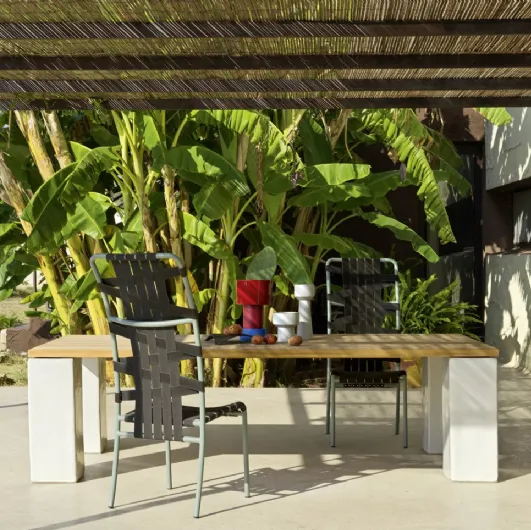 Inout table in teak and concrete by Gervasoni.