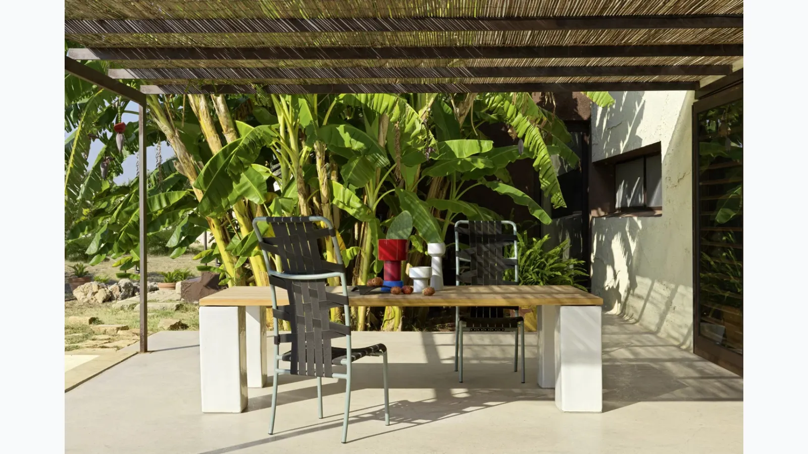 Inout table in teak and concrete by Gervasoni.