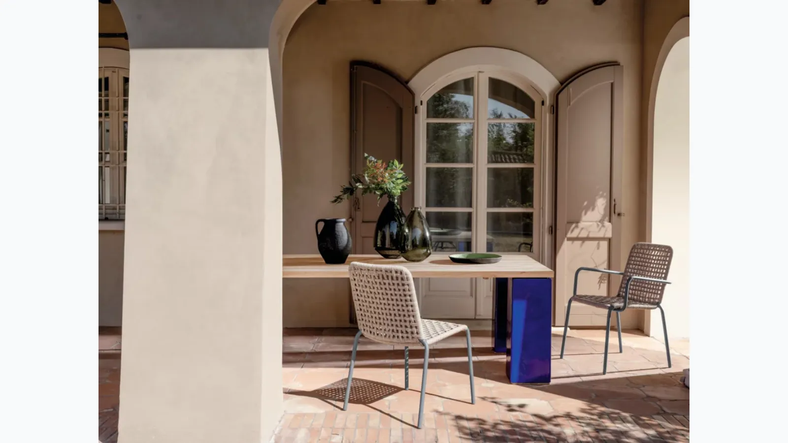 Inout table in teak and cement by Gervasoni.