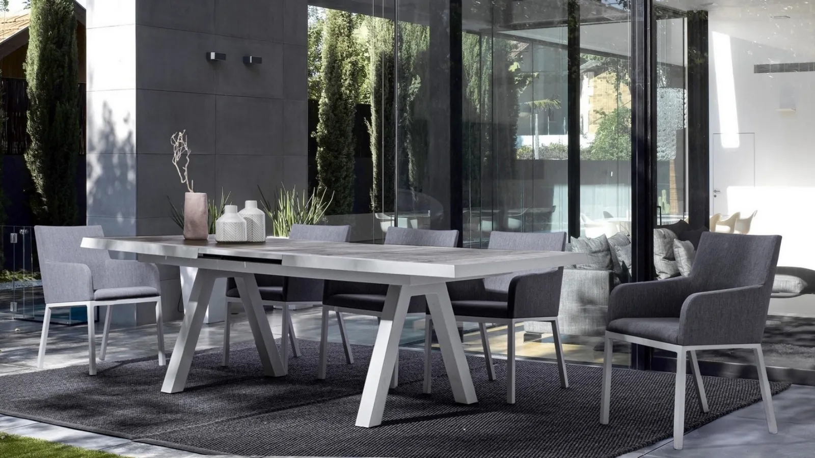 Ceramic table and Lunar padded chairs by Bizzotto.