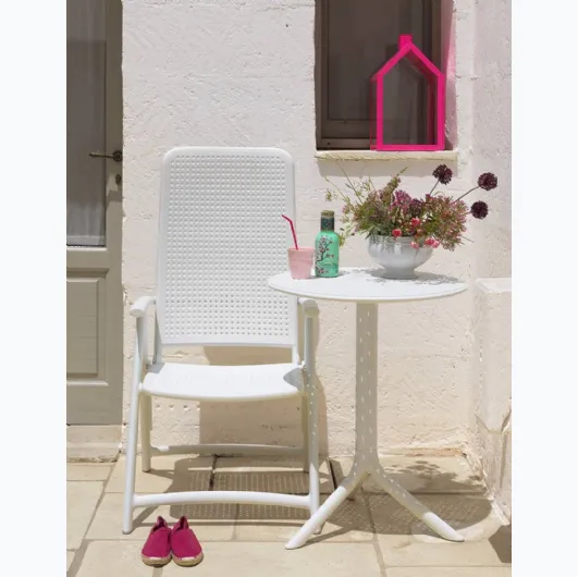 Outdoor side table with a round top characterized by decorative little holes, three-legged base, easy to assemble and disassemble, offered with a kit that allows you to obtain two different heights, Step by Nardi.