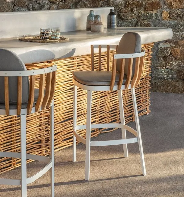 Swing stool in teak and aluminum by Ethimo.