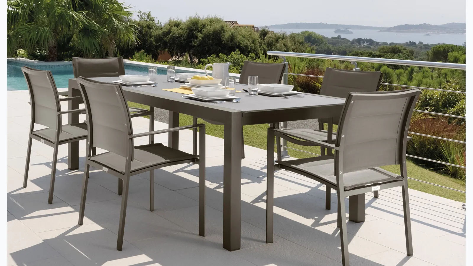 Extendable glass and aluminum table with chairs in fabric and aluminum Touch by Talenti.