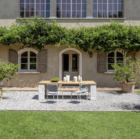 Inout table in teak and concrete by Gervasoni.