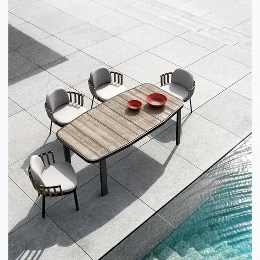 Swing armchair in teak and aluminum by Ethimo.