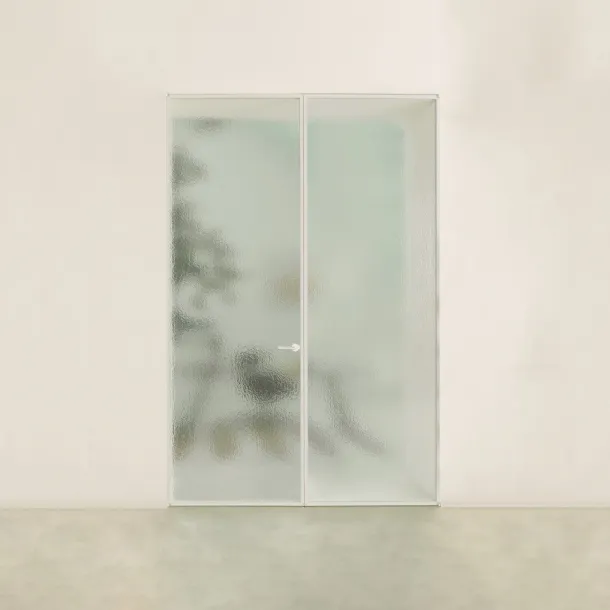 The Aladin Double Swing Plain Duo interior door in glass with an aluminum frame by Glas Italia.